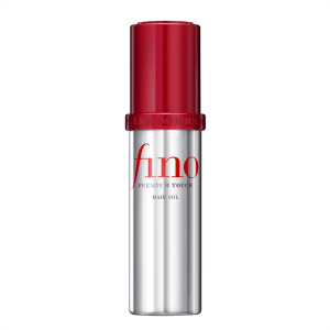 A sleek, golden bottle of Fino Premium Touch Hair Oil placed on a softly blurred background, highlighting its lightweight, shine-enhancing, and frizz-controlling formula.