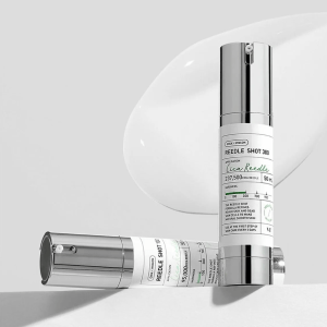 A sleek, science-driven bottle of VT Cosmetics Reedle Shot placed on a softly blurred background, emphasizing its innovative micro-spicule technology for collagen boosting, skin renewal, and enhanced absorption.