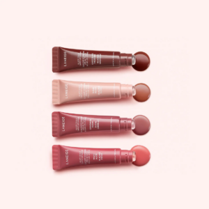 Flat lay of the four Laneige Glaze Craze Tinted Lip Serums, each shade with its corresponding lip color swatch: Chocolate Frosting, Sugar Glaze, Cinnamon Sugar, Peach Glaze.