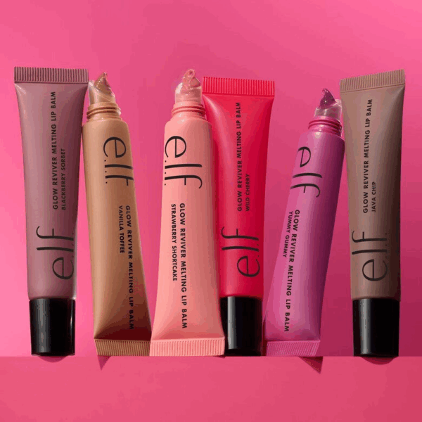 Angled layout of all six e.l.f. Glow Reviver Melting Lip Balm tubes against a pink background, showing the product in vibrant, color-matched packaging.
