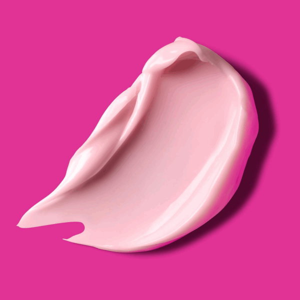 Closeup pink cream smear on a bright fuchsia background showing rich texture