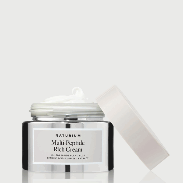 Open jar of Naturium Multi Peptide Rich Cream on a reflective base with creamy texture visible