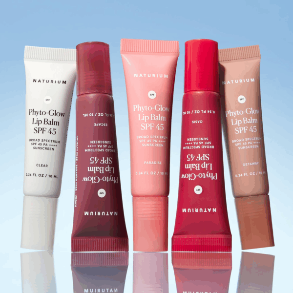 Lineup of Naturium Phyto-Glow Lip Balm SPF 45 tubes in clear and tinted shades