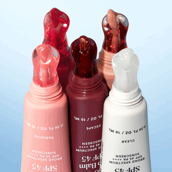 Close-up of Naturium Phyto-Glow Lip Balm SPF 45 tubes showing product tips with glossy balm