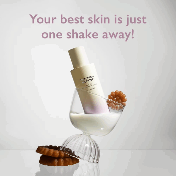 Bottle balanced in a glass of milky liquid with jelly desserts and caption your best skin is just one shake away