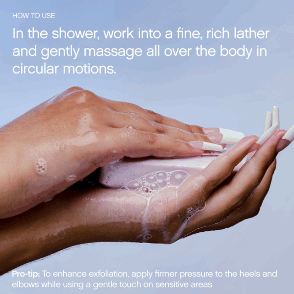 Hands working the Topicals Slather body bar into a rich lather in the shower.