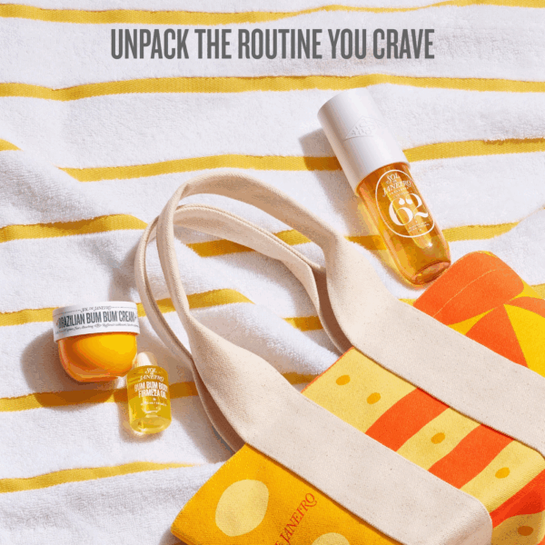 Flat lay of mini tote with Bum Bum Cream mini Firmeza Oil mini and Cheirosa 62 Mist on a striped towel