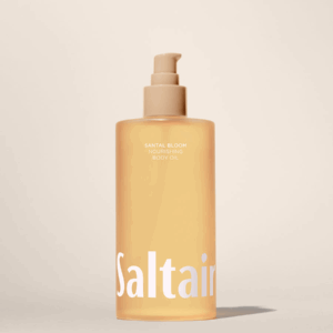 Saltair Santal Bloom Nourishing Body Oil bottle standing on a beige background.”