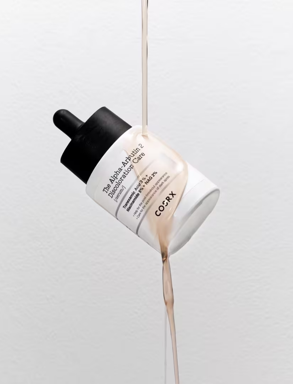 COSRX Alpha Arbutin 2 serum dripping texture showing hydration and brightening.