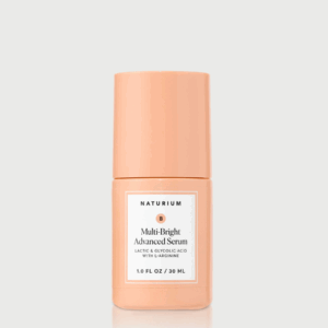 Naturium Multi-Bright Advanced Serum bottle on a soft peach background