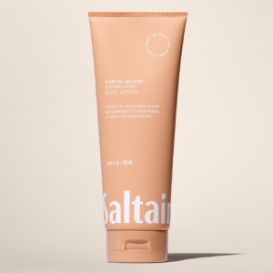 Saltair Santal Bloom Nourishing Body Lotion tube on a warm beige background showcasing minimal packaging design.