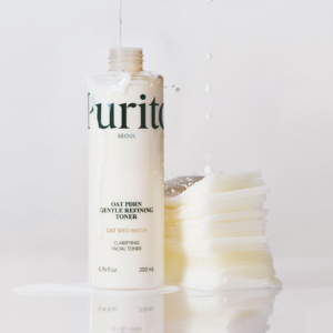 Purito Oat PDRN Gentle Refining Toner bottle with cotton pads and milky texture on white background